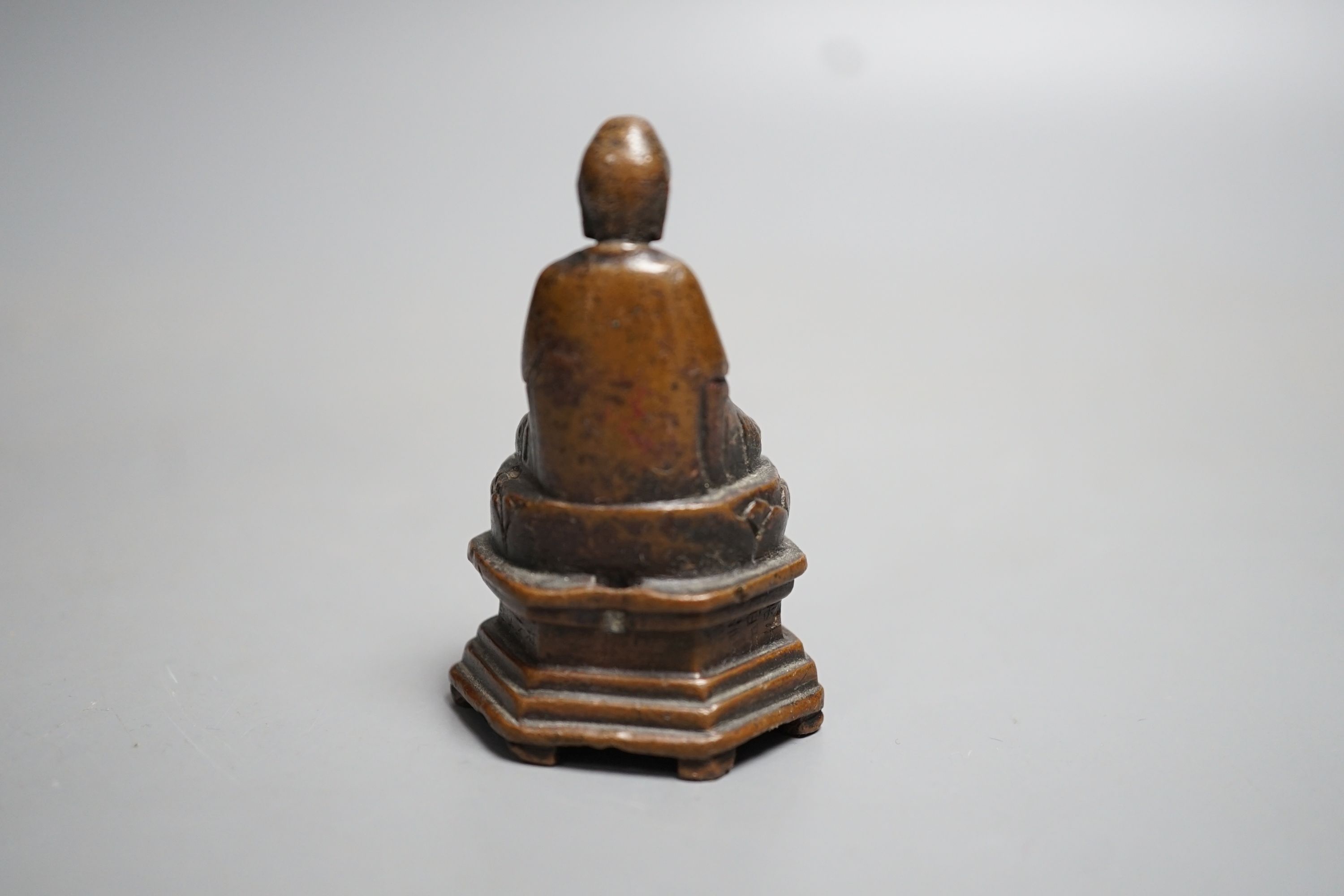 A small 19th century bronze figure of Buddha seated and a Burmese silver overlaid wood figure of Buddha, largest 7.5cm
